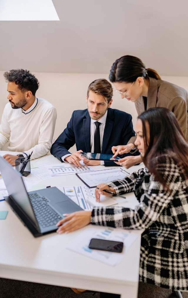 Executives working with a presenter in a conference room during a live practice session