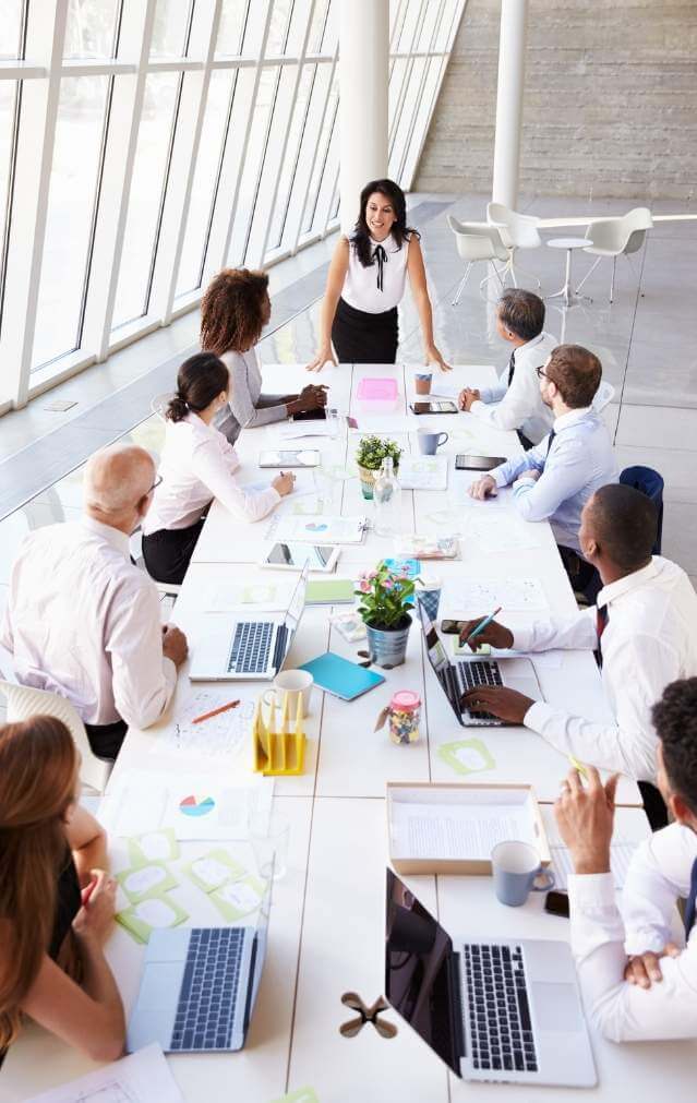 Facilitated leadership session with executives aligning in a boardroom